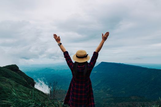 Woman travel rainy season mountain view relax in the holiday