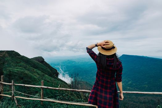 Woman travel rainy season mountain view relax in the holiday