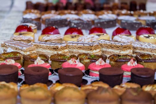 A variety of cakes on display at a market cake stall