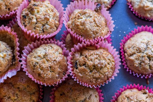 Homemade apple and sultana muffins in pink wrappers