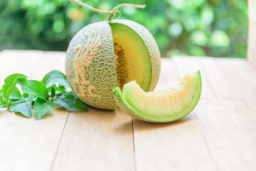 Fresh green melon with liverpool logo on wood plate