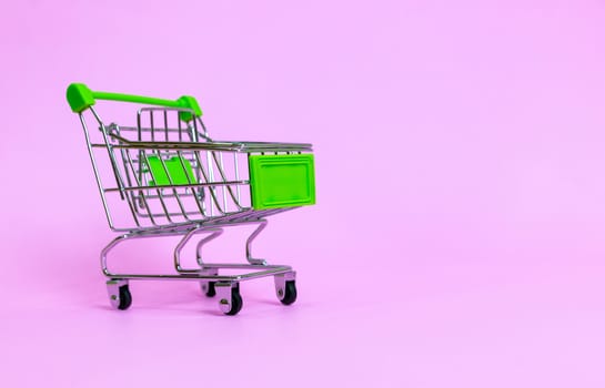 Shopping cart in the supermarket on a purple background