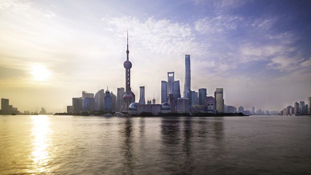 Shanghai city skyline Pudong side looking through Huangpu river on morning time. Shanghai, China. Beautiful vibrant panoramic image.