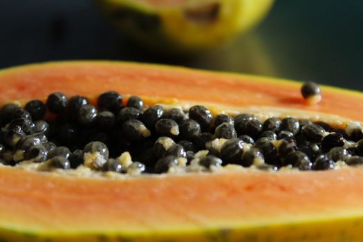 Macro of papaya fruit seeds on the kitchen table.