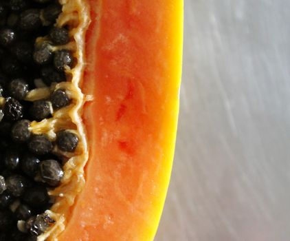 Macro papaya. Macro papaya seeds. Close up of papaya fruit on the kitchen table.