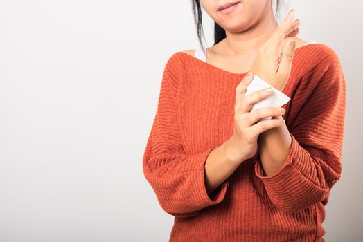 Close up hand of Asian woman she using wet tissue paper wipe cleaning her hands, studio shot isolated on white background, Healthcare medicine body care concept