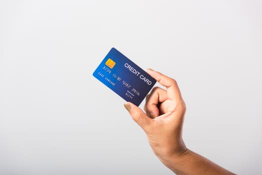 Close up hand of Asian woman she holding bank credit card for pay money online shopping, studio shot isolated on white background