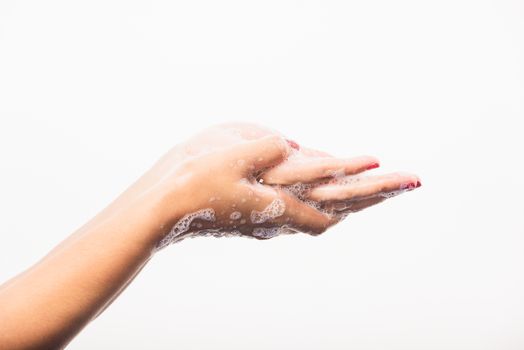 Closeup young Asian woman washing hands by soap for cleanliness and prevent germs coronavirus, studio shot isolated on white background, Healthcare medical COVID-19 virus concept