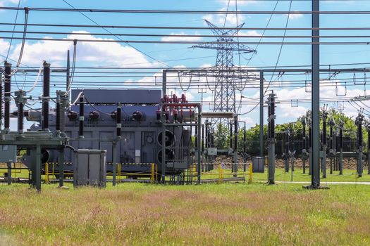 Electrical Transformer. Distribution of electric energy at a big substation with lots power lines