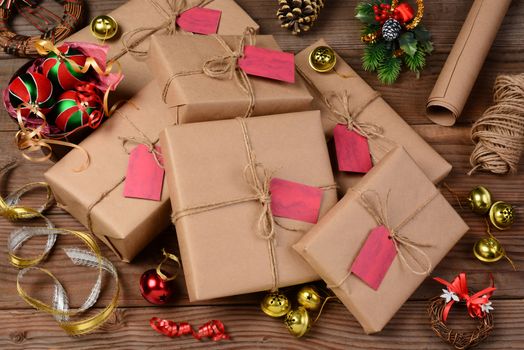 Christmas still life with eco friendly wrapping paper and supplies. Horizontal format shot from a high angle.