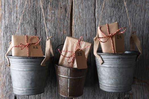 An Advent Calendar made of buckets with dated gifts inside.