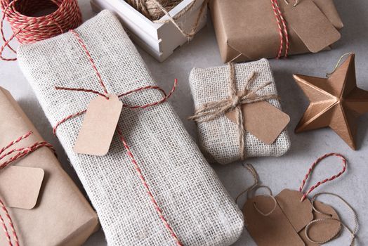 Wrapping Christmas Presents. High angle shot of a group of fabric and paper wrapped presents.