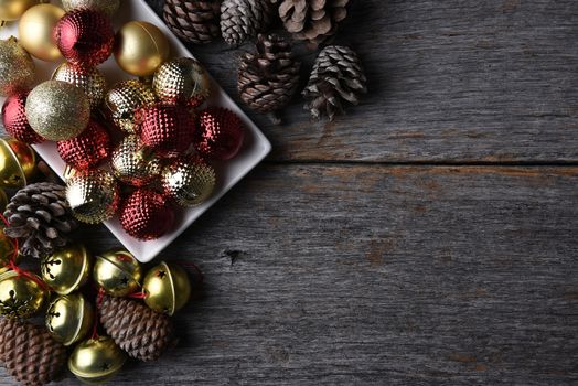 Christmas ornaments and decorations on a rustic wood table with copy space.