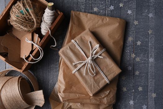 High angle shot of plain brown paper gift wrapping supplies with paper stars.