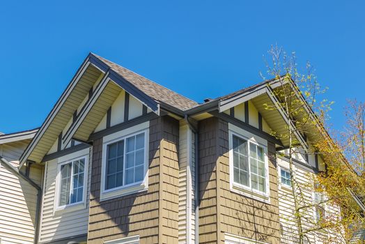 Top of new townhouses on blue sky background