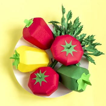 Colorful paper tomatoes, peppers and parsley on paper plate. Real volumetric handmade paper objects. Paper art and craft
