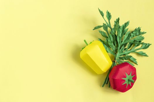 Colorful tomato, pepper and parsley on yellow background. Real volumetric handmade paper objects. Paper art and craft