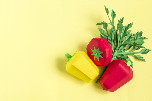 Colorful omato, pepper and parsley on yellow background. Real volumetric handmade paper objects. Paper art and craft