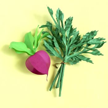 Colorful paper radish and parsley on paper plate. Real volumetric handmade paper objects. Paper art and craft