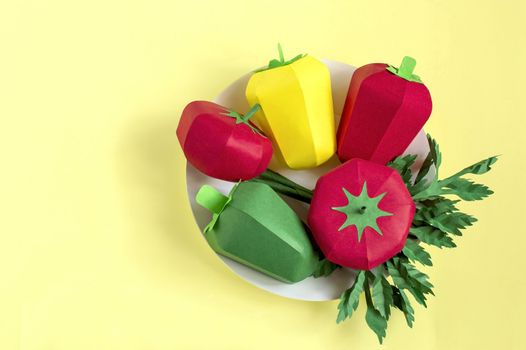 Colorful paper tomatoes, peppers and parsley on paper plate. Real volumetric handmade paper objects. Paper art and craft