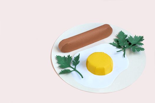 Paper fried eggs with sausage and parsley on plate. Real volumetric handmade paper objects. Paper art and craft