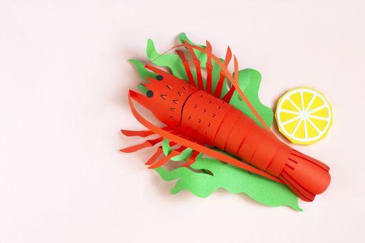 Paper lobster with lettuce and lemon slices. Real volumetric handmade paper objects. Paper art and craft
