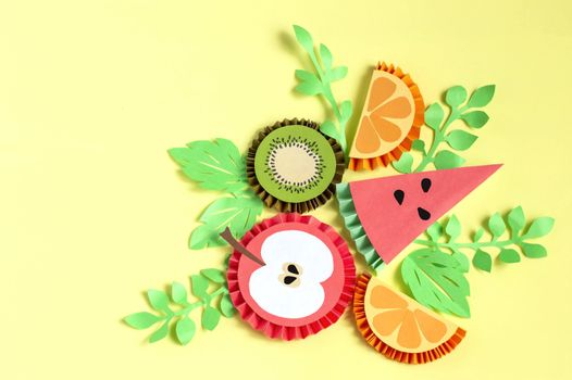 Fruit made from paper with paper leaves on yellow background. Paper art and craft