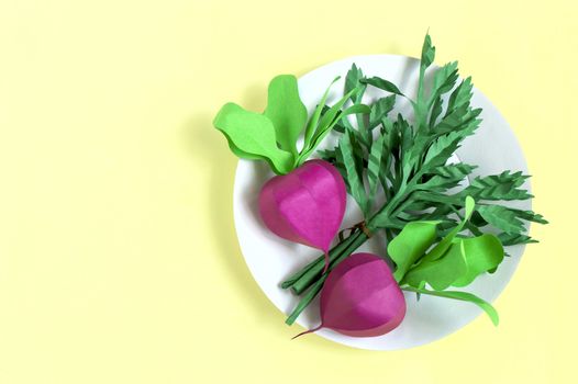 Colorful paper radish and parsley on paper plate. Real volumetric handmade paper objects. Paper art and craft