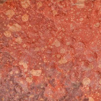 Red rough stone texture background. Material construction and architectural detail.