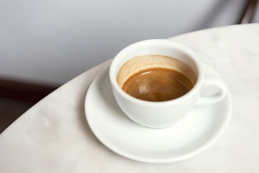 Espresso shot coffee ,top view on marble table in cafe.