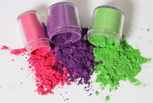 Colorful Cosmetic Pigments in jars Purple Green and Pink