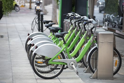 Bicycle rental station on public parking in the city.