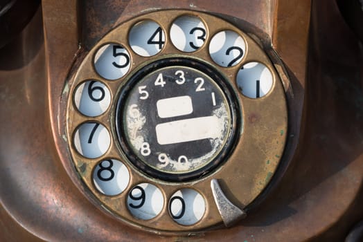 old brown antique rotary style telephone close-up