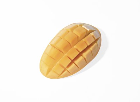 Fresh mango slice cut to cubes isolated on white background.