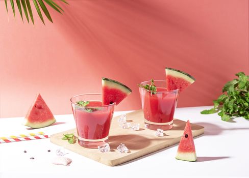 Fresh water melon juice and watermelon slice on red background. summer drink.