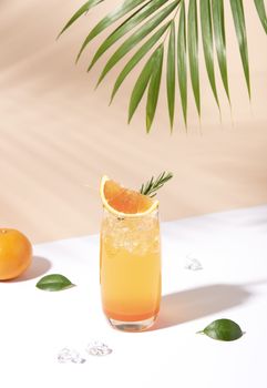 Cold and refreshing orange punch cocktail with orange slice on color background. summer drink.