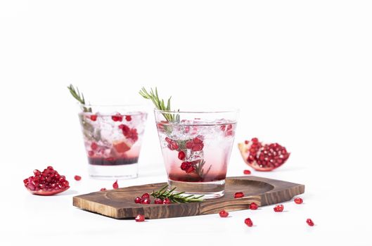 Pomegranate juice with ripe pomegranate on white background. summer drink.