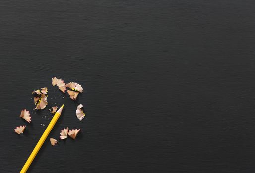 Yellow pencil on blackboard banner background. top view with copy space.