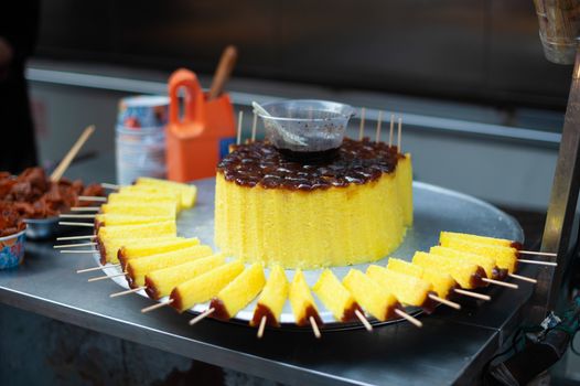 GuiHuaGao yellow glutinous rice cake skewers in a street market in a street market in Xi'an, Shaanxi province, China