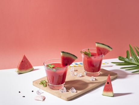 Fresh water melon juice and watermelon slice on red background. summer drink.