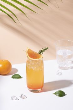 Cold and refreshing orange punch cocktail with orange slice on color background. summer drink.