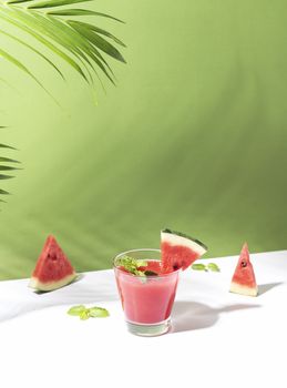 Fresh water melon juice and watermelon slice on color background. summer drink.