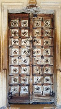 Antique rustic ancient wooden door. Architectural element.