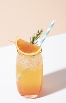 Cold and refreshing orange punch cocktail with orange slice on color background. summer drink.