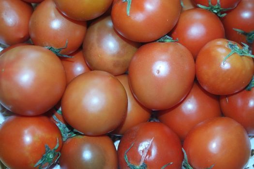 Close-up view of red tomatoes in market for sale. A fruit background for text and advertisements