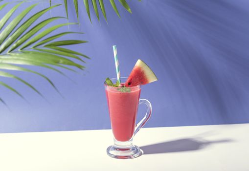 Fresh water melon juice and watermelon slice on color background. summer drink.