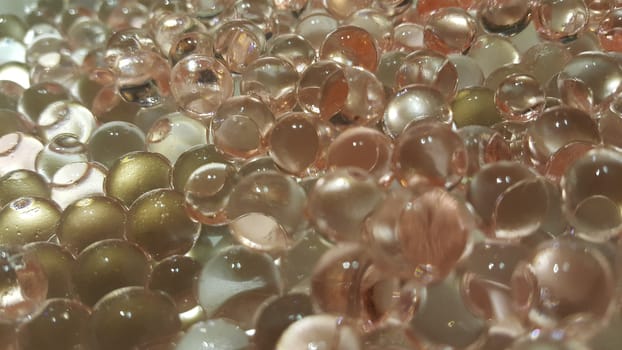 Closeup view with selective focus of shiny glittering orbeez or colorful water balls hydrogel. Water beads orbeez background.