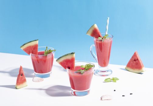 Fresh water melon juice and watermelon slice on color background. summer drink.