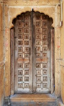 Antique rustic ancient wooden door. Architectural element.