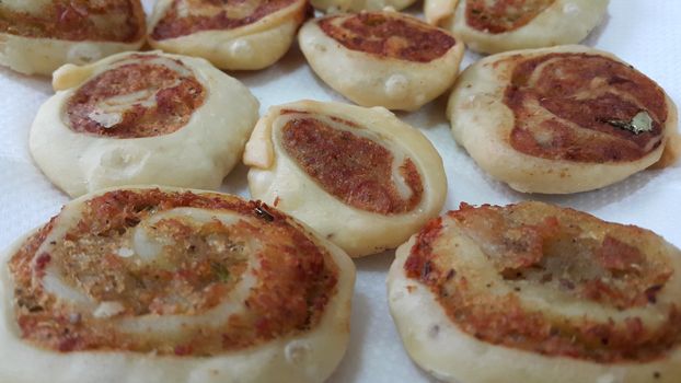 Closeup of delicious home made pinwheel puff pastries food item placed over white background